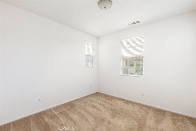 empty room featuring light colored carpet