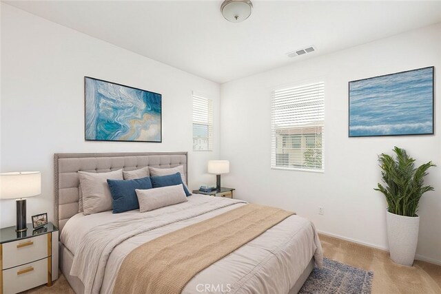 bedroom featuring multiple windows and light colored carpet