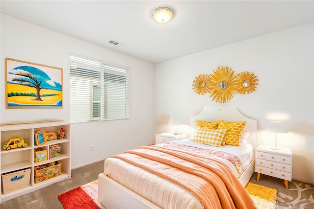 carpeted bedroom featuring visible vents