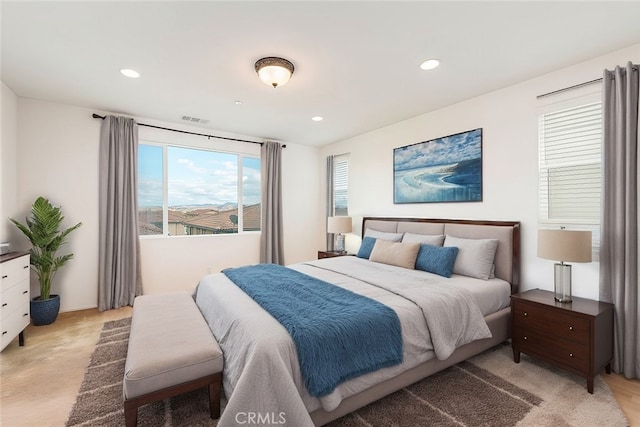 bedroom with recessed lighting, visible vents, and light carpet