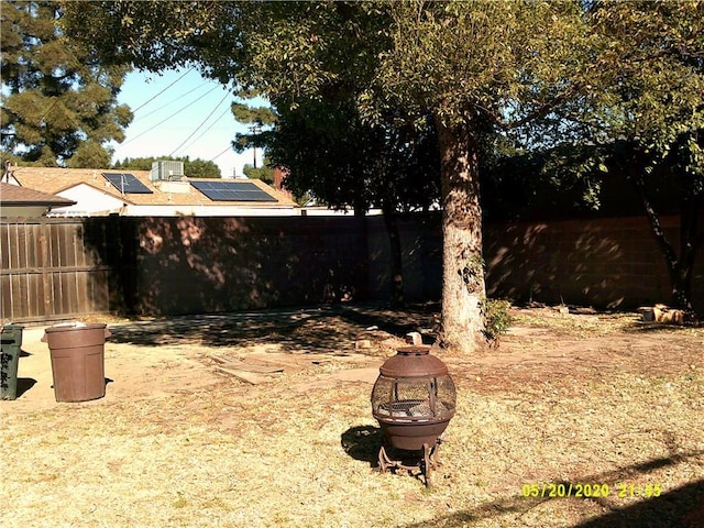 view of yard featuring an outdoor fire pit