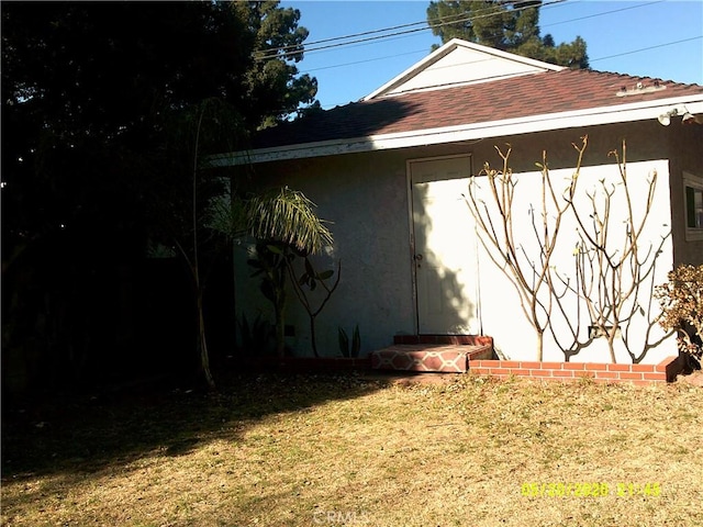 view of side of property with a yard