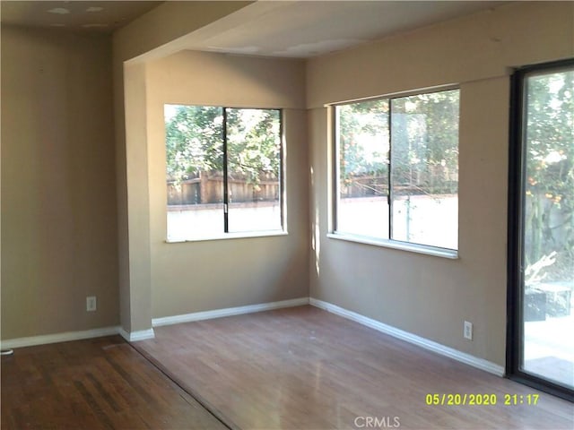 unfurnished room with wood-type flooring