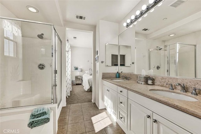 bathroom with tile patterned flooring, vanity, and a shower with door