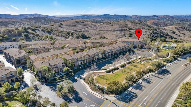 birds eye view of property featuring a mountain view