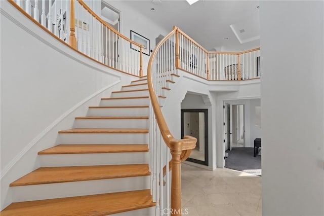 staircase with a high ceiling