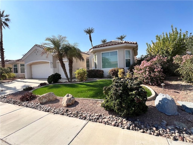 view of front of property featuring a garage and a front yard