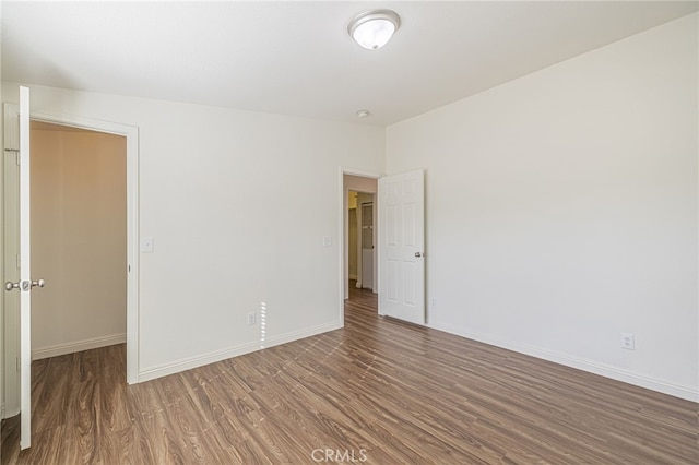 spare room with dark hardwood / wood-style flooring