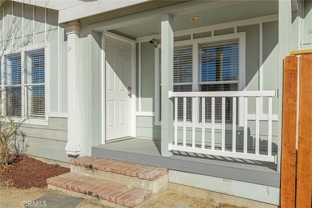 view of exterior entry featuring a porch