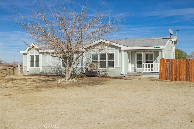 back of property with a porch