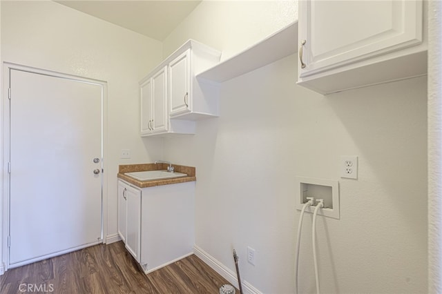 washroom featuring cabinets, hookup for a washing machine, sink, and dark hardwood / wood-style flooring