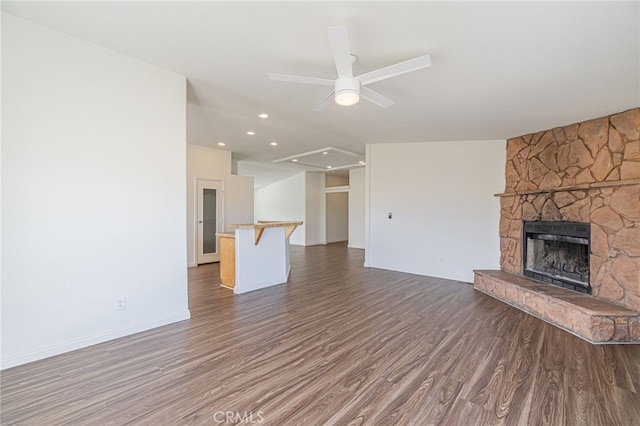 unfurnished living room with ceiling fan, a fireplace, and dark hardwood / wood-style floors