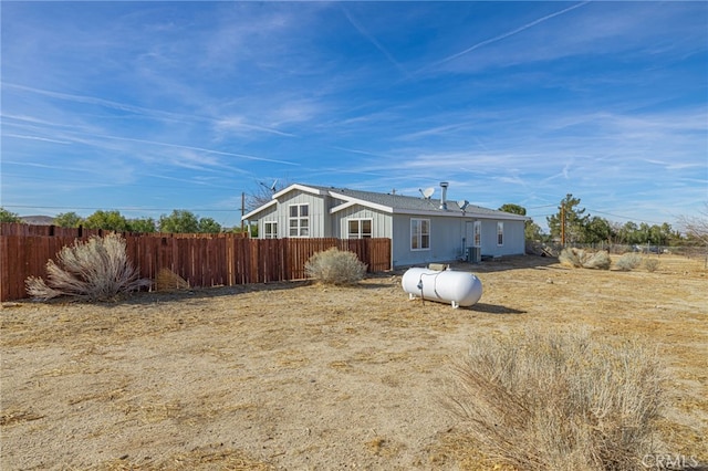 back of house with central AC unit