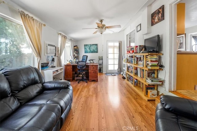 home office with ceiling fan, lofted ceiling, a wall mounted AC, and light wood-type flooring