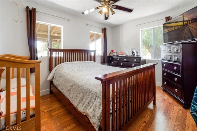 bedroom featuring light hardwood / wood-style floors and ceiling fan