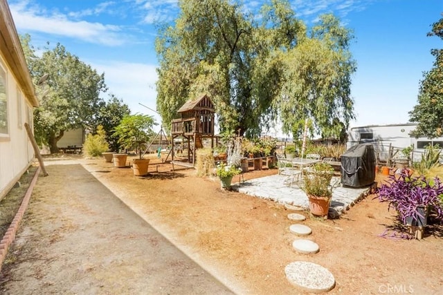 view of jungle gym featuring a patio area