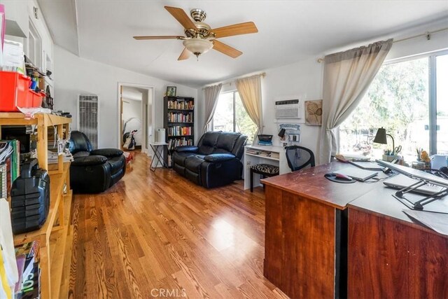 home office with ceiling fan, wood-type flooring, vaulted ceiling, and a wall unit AC