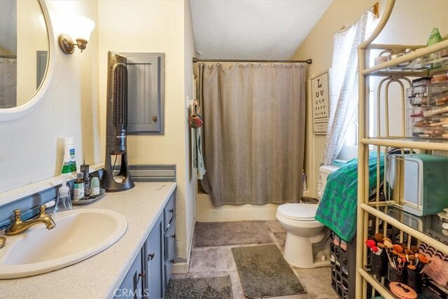 full bathroom featuring shower / tub combo, vanity, and toilet