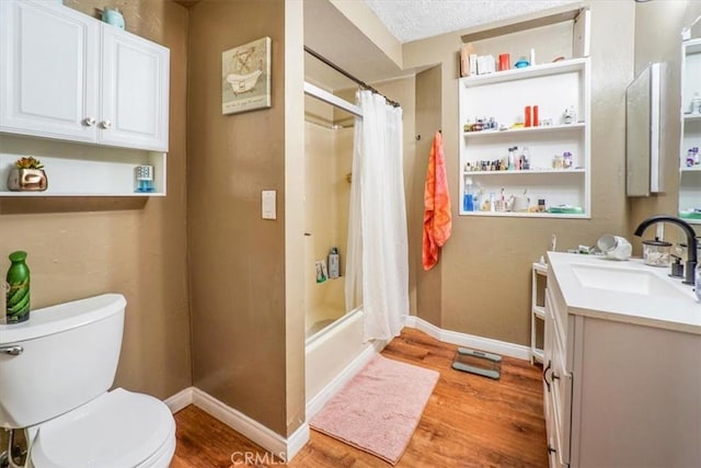 full bathroom featuring hardwood / wood-style floors, shower / bath combination with curtain, vanity, toilet, and a textured ceiling