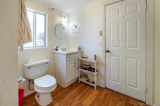 bathroom featuring hardwood / wood-style flooring, vanity, and toilet