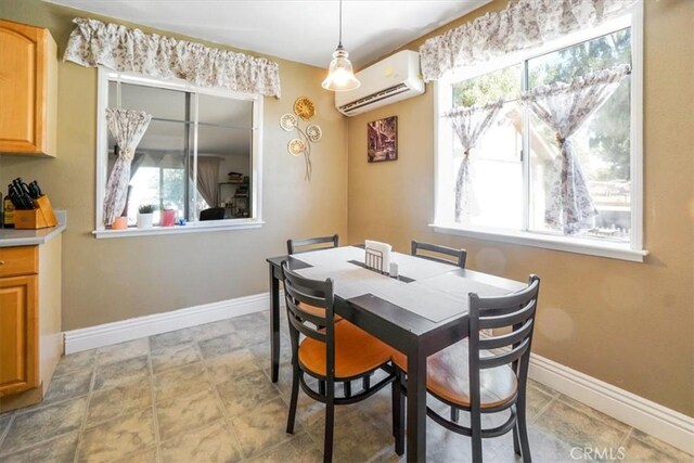 dining space featuring a wall unit AC