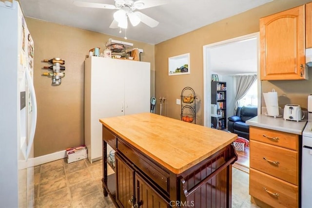 kitchen featuring white fridge with ice dispenser, ceiling fan, and white refrigerator