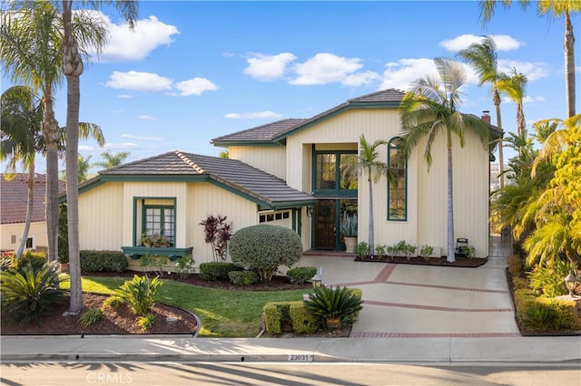 view of front of home with a garage and a front lawn