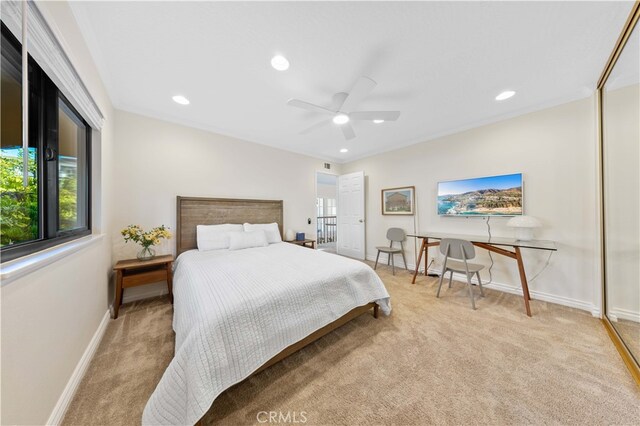 bedroom with ceiling fan and light colored carpet