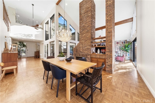 dining area with a towering ceiling, plenty of natural light, and light parquet floors