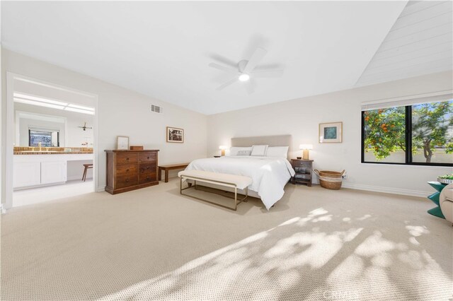 bedroom featuring ceiling fan, lofted ceiling, carpet flooring, and ensuite bath