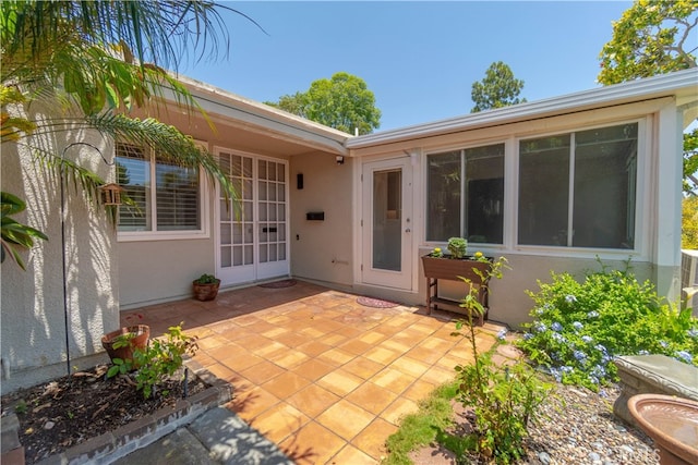 394 Avenida Castilla Unit F, Laguna Woods, CA 92637 - view of exterior entry with stucco siding and a patio