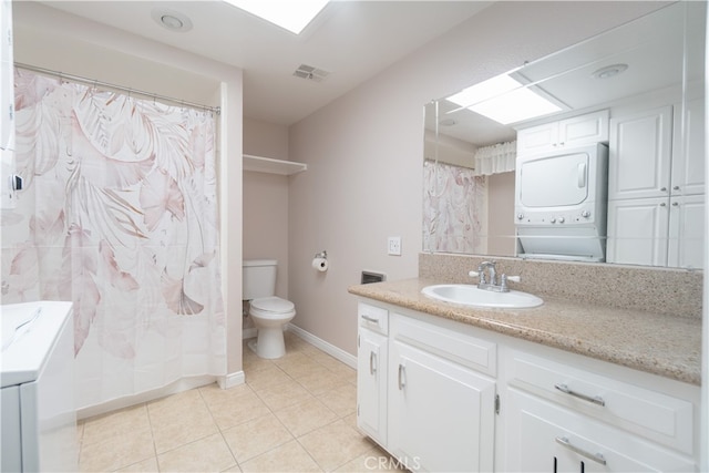 394 Avenida Castilla Unit F, Laguna Woods, CA 92637 - bathroom featuring stacked washer / drying machine, vanity, tile patterned floors, and a shower with shower curtain