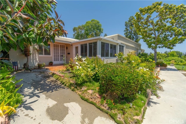 394 Avenida Castilla Unit F, Laguna Woods, CA 92637 - view of front of home with a sunroom and stucco siding