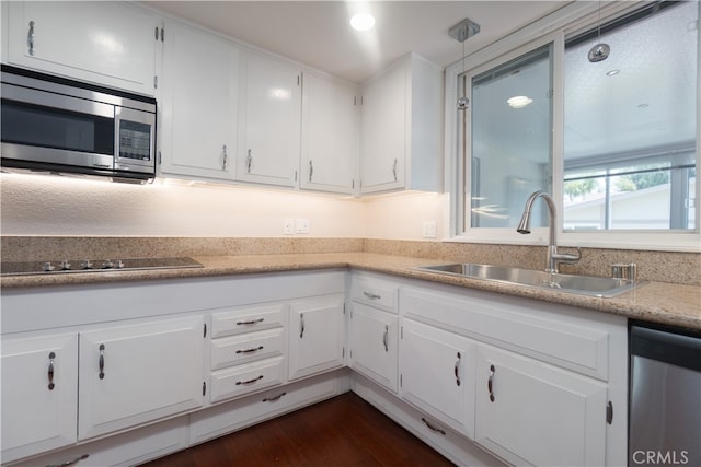 394 Avenida Castilla Unit F, Laguna Woods, CA 92637 - kitchen with appliances with stainless steel finishes, white cabinetry, and dark wood-type flooring