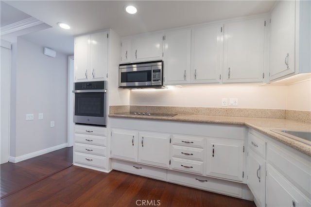 394 Avenida Castilla Unit F, Laguna Woods, CA 92637 - kitchen featuring stainless steel appliances, dark wood finished floors, white cabinets, recessed lighting, and light stone countertops