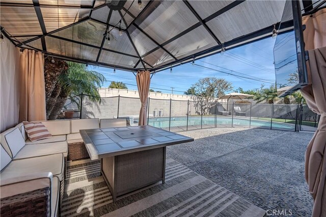 view of patio / terrace featuring a fenced in pool, a gazebo, and an outdoor hangout area