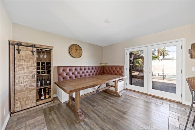 dining room with french doors and wood-type flooring