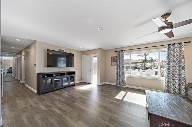 unfurnished living room featuring dark hardwood / wood-style floors and ceiling fan