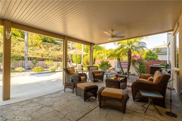 sunroom featuring ceiling fan