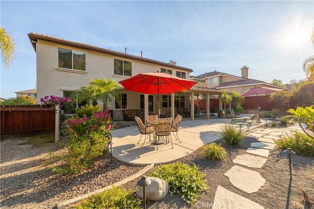 rear view of property featuring a patio area