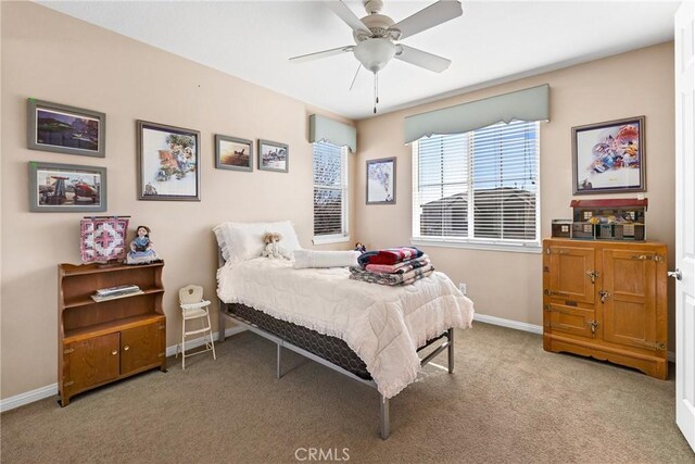 bedroom featuring light colored carpet and ceiling fan