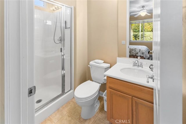 bathroom with vanity, toilet, and a shower with door