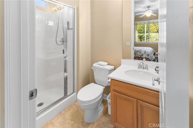 ensuite bathroom with vanity, a stall shower, ensuite bathroom, tile patterned floors, and toilet