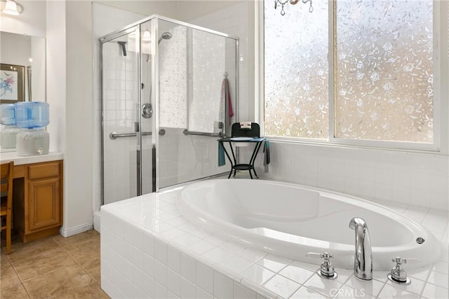 full bathroom featuring tile patterned floors, a stall shower, vanity, and a bath