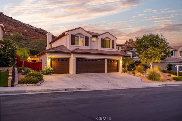 view of front of house with a garage and a mountain view