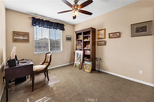 carpeted office space with ceiling fan