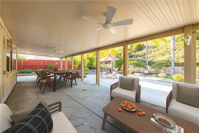 sunroom / solarium with a ceiling fan