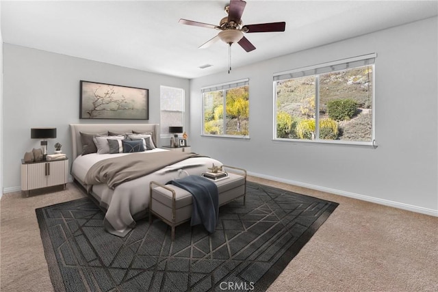 carpeted bedroom featuring a ceiling fan, visible vents, and baseboards