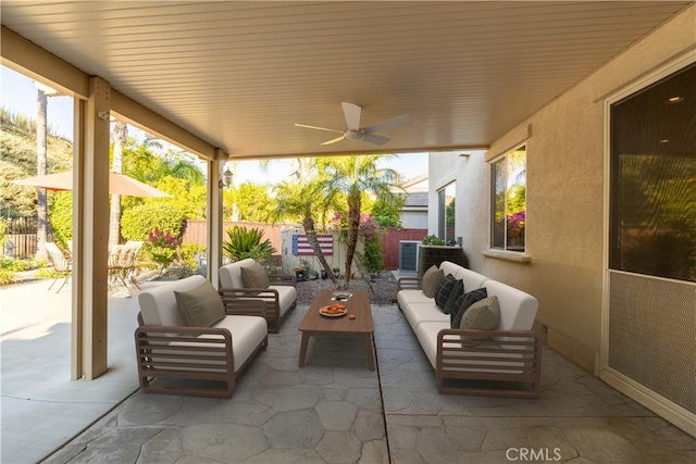 view of patio featuring an outdoor living space, a ceiling fan, and fence