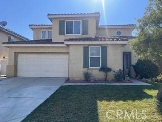 view of front of home featuring a garage and a front yard